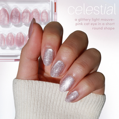 Against a white background, a hand showcases salon-quality, glittery light mauve-pink cat eye acrylic nails. Beside it, a box from Glowie By Her contains the "Celestial" 100% customizable nail set.