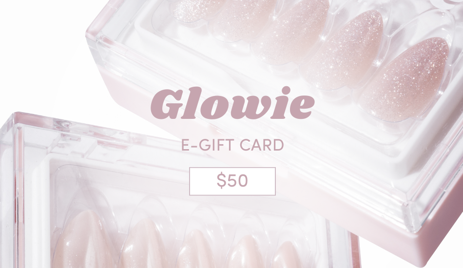 The image displays a $50 Glowie Co. Gift Card featuring pink, glittery press-on nails in clear boxes. The card's soft pink and white salon-inspired design is ideal for nail enthusiasts seeking a glam touch.