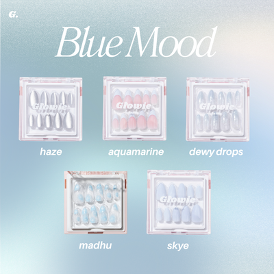 An image titled "Blue Mood" highlights the Blue Mood collection from Glowie By Her, featuring salon-quality nails available in five uniquely designed decorative nail sets. Named haze, aquamarine, dewy drops, madhu, and skye, each box provides distinct designs in soft, cool tones ideal for any occasion. Enjoy a new look with 25% off this offer!