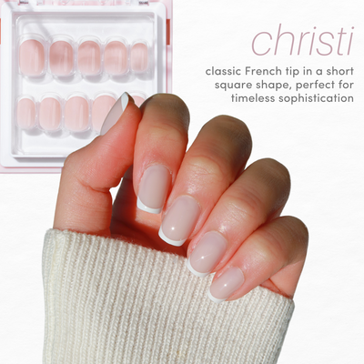 A hand with neatly manicured nails displaying a classic French tip design in a short square shape is shown. Above the hand is a box containing similar French tip nail sets. The text reads: "Glowie By Her - Essentials Collection 2.0 (20% Off) featuring classic French tips in a short square shape for timeless sophistication.