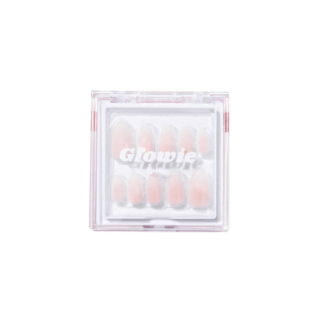 A clear plastic container branded "Glowie By Her" houses a set of Daydream Press-On Nails (Short) in various sizes. The salon-quality, pink short almond style nails are neatly arranged and visible through the lid of the container, ensuring convenience and easy selection.