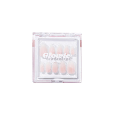 A clear plastic container branded "Glowie By Her" houses a set of Daydream Press-On Nails (Short) in various sizes. The salon-quality, pink short almond style nails are neatly arranged and visible through the lid of the container, ensuring convenience and easy selection.