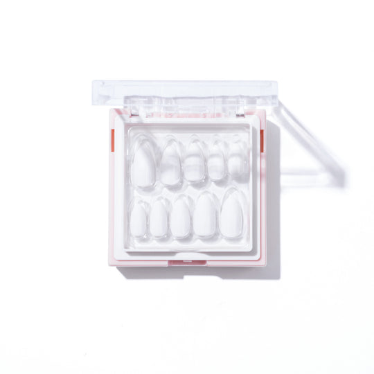A set of Glowie Co.’s Snow White almond-shaped nails is neatly arranged in a segmented clear plastic case with a transparent lid, resting on a white background and casting a soft shadow.