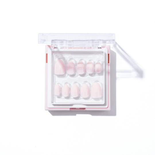 The Sofia set from Glowie By Her features salon-quality, soft pink nails in various sizes, all neatly arranged in a clear and white square plastic case against a white background.