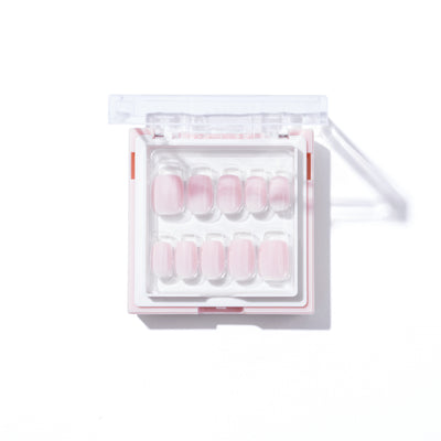 The image shows a set of Glowie By Her Pillowtalk Press-On Nails in a clear plastic box with a transparent lid. The nails, which are arranged in two rows, appear to be in a light pink shade.