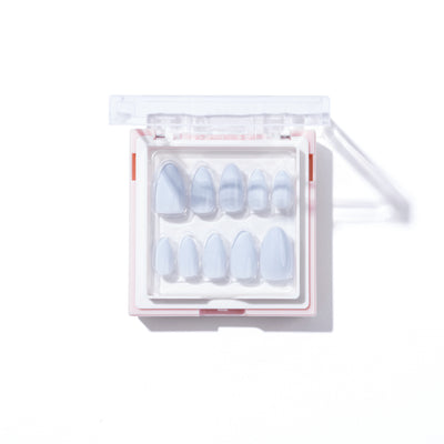 The Skye Press-On Nails by Glowie By Her are a salon-quality set available in various sizes, stored in a clear, rectangular case with rounded edges. The nails feature a light, translucent blue hue and are neatly arranged in two rows inside the open case on a white background. These 100% customisable nails provide both style and convenience.