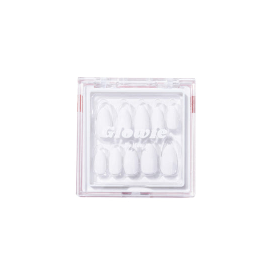 A clear plastic box from Glowie Co. holds salon-quality, white almond-shaped nails named "Snow White," featuring a simple and sleek design with the nails neatly arranged in rows for easy application.