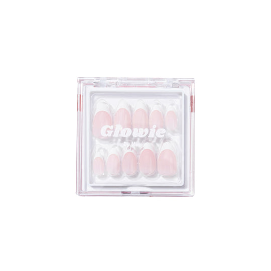 A clear box showcases "That Girl," a set of pastel pink press-on nails from Glowie Co., offering salon-quality style. These French nails are 100% customizable, ensuring you achieve the perfect look for any occasion.